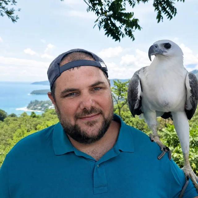Dr Marko Raković with a bird of prey perched on his shoulder