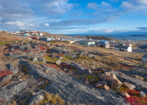 Overview of the city of Iqaluit with the Arctic Ocean harbor in the distance