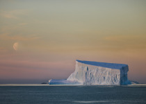Tabular iceberg and moon