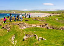 Orkney, Scotland - People visiting the stone remains of the Neolithic village of Skara Brae, on the Orkney coast.